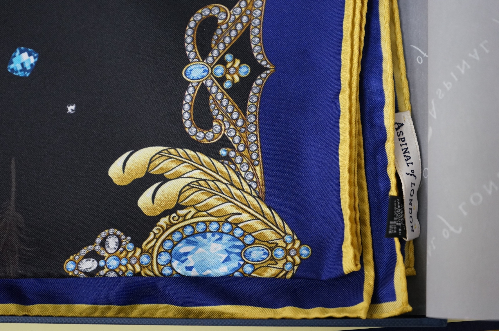 Aspinal of London silk scarf, with a printed feather design, boxed, 80cm x 85cm. Condition - good